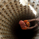 A Palestinian smuggler climbs down into a tunnel, temporarily closed by Hamas forces, beneath the Egyptian-Gaza border in Rafah in the southern Gaza Strip April 14, 2010. Israel wants to close down the smuggling tunnels between Egypt and the Gaza Strip, but the tunnelers have become so good it's now possible to drive a car through them, literally.